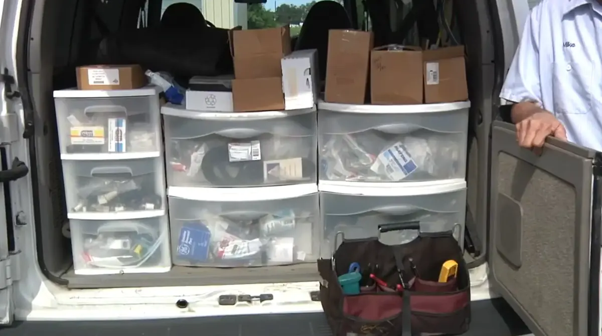 Common repair parts organized in bins inside a Bradenton Appliance Pros service van