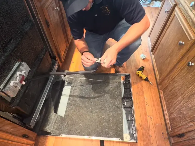 Technician repairing a dishwasher door latch during dishwasher repair in Bradenton