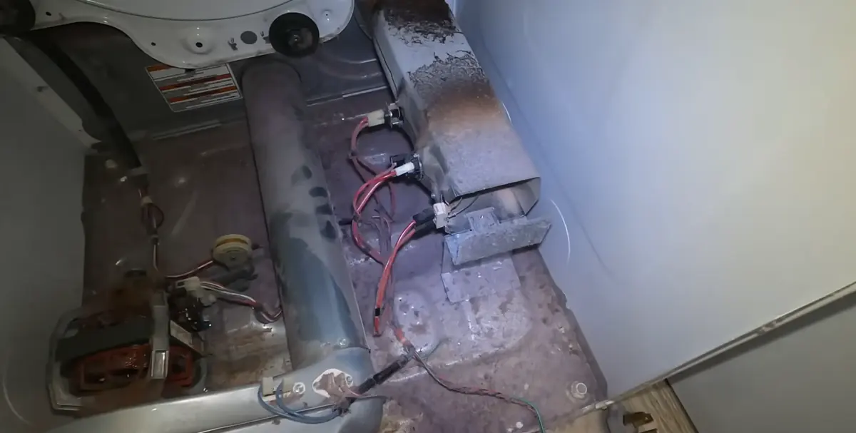 Lint buildup around a dryer heater housing found during dryer repair in Bradenton