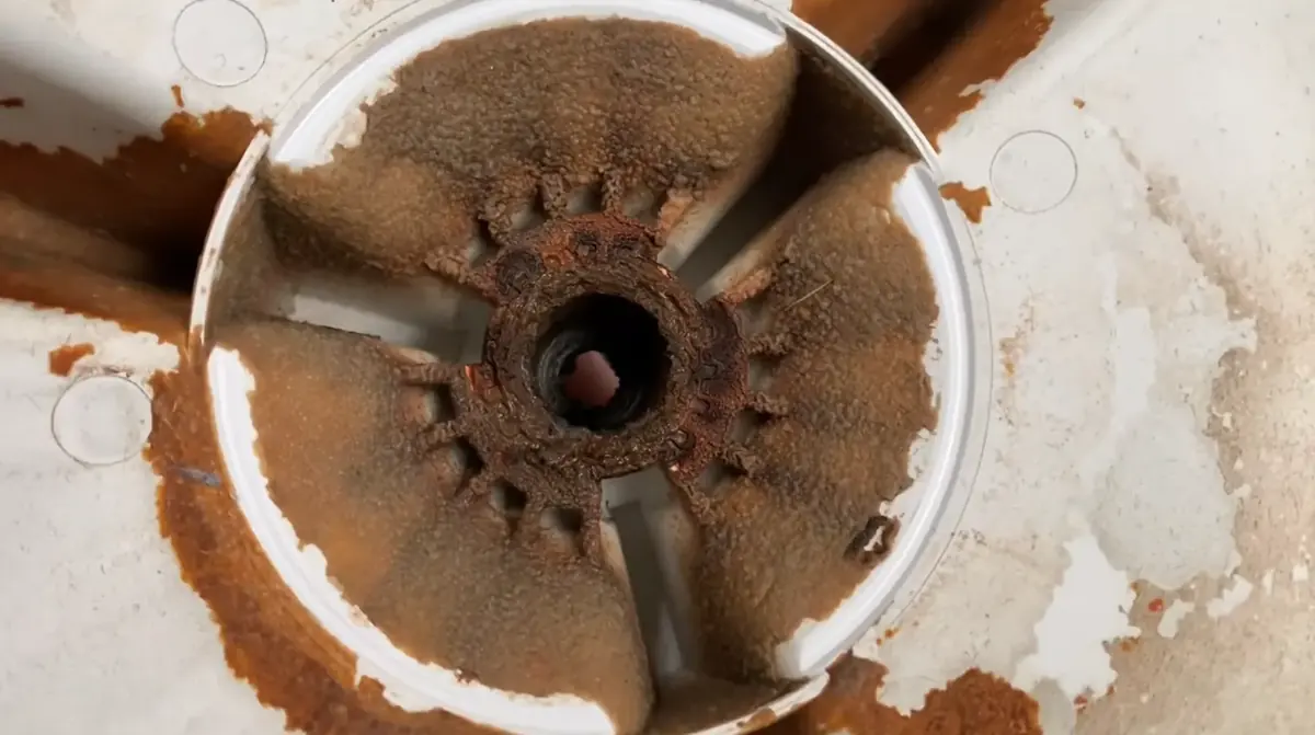 Rusted drive hub under a top load washer basket found during washer repair in Bradenton